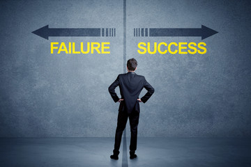 Fototapeta na wymiar Businessman standing in front of success and failure arrow concept on grungy background