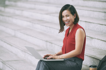 Smiling business lady with laptop