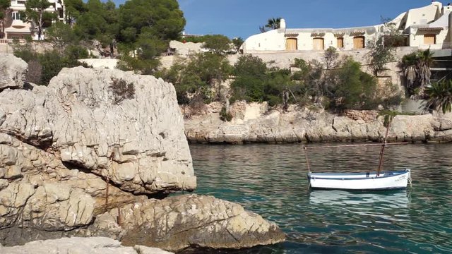 Boat in idyllic bay of Cala Fornells on Majorca island, Spain 