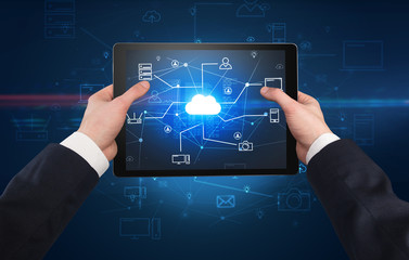 First person view of a hand using tablet with cloud office concept
