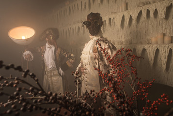 Actors in Steam punk masks and antique costumes indoor.