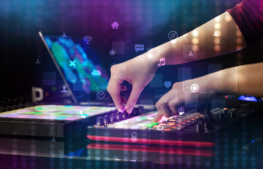 Obraz na płótnie Canvas Hand mixing music on dj controller with social media concept icons 