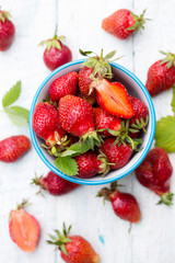 Juicy strawberries in a blue bowl