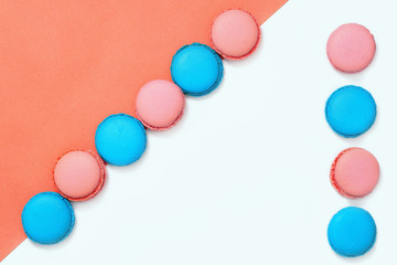 Line from pink and blue macaroons. Minimal concepts. Tasty almond cookies. Copy space. Top view.