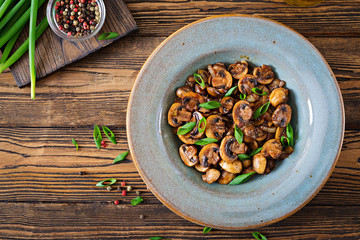 Baked mushrooms with soy sauce and herbs. Vegan food. Top view