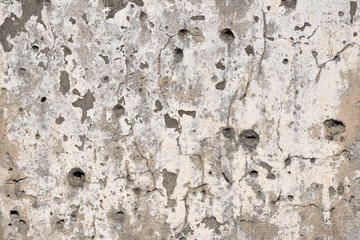 Concrete wall background with bullet holes