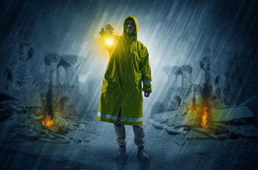 Obraz premium Destroyed place after a catastrophe with man in raincoat and lantern concept 