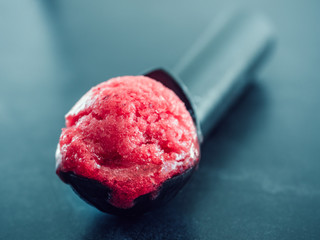 Crimson, refreshing berry ice cream and a vintage spoon for ice cream. Close-up. Homemade food. Tasty, useful, positive