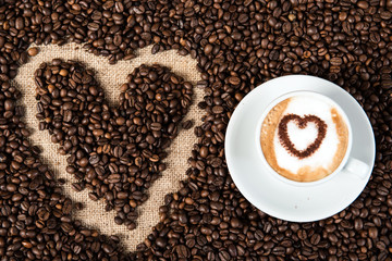 cappuccino on a lot of coffee beans