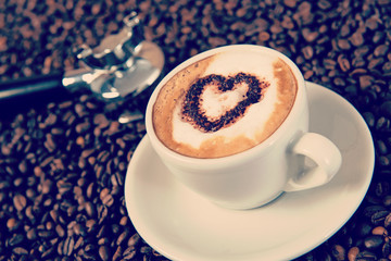 cappuccino on a lot of coffee beans