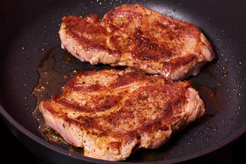 grilled meat steak with spices on fying pan