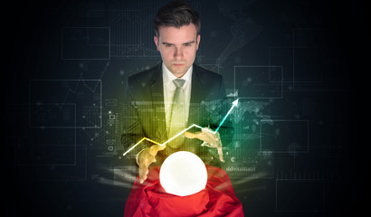 Young businessman making predictions of the future of the stock market with a magic ball
