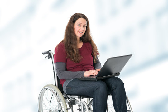woman in wheelchair working with the computer