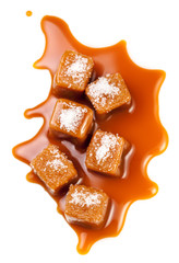 Isolated caramel. Salted Caramel candies pieces  and topping sauce  isolated on white background. Flat lay. Food concept.