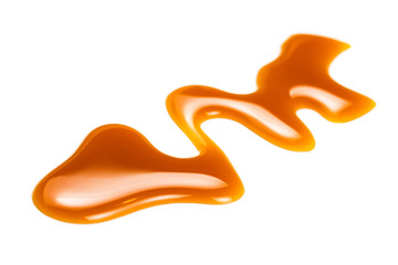 Isolated caramel  pouring  sauce.  Flowing Toffee drop isolated on white background.  Food concept....