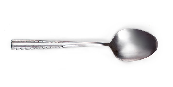 Steel tablespoon. Dinning silver spoon isolated on white background. Kitchen utensils concept, close up.