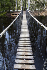 hanging wooden bridge across the river