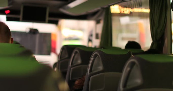 Passenger perspective inside bus. POV of person riding travel bus