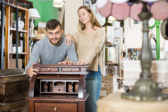 Couple satisfied with purchase of writing cabinet