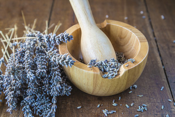 Bouquet of lavenders, wooden mortar and pestle
