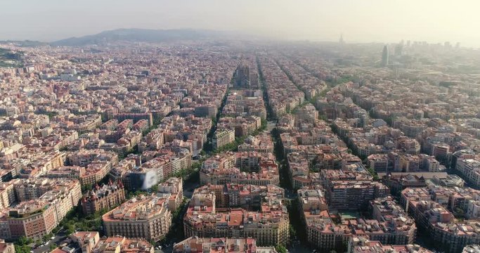 Aerial view of Barcelona city skyline with morning light, Spain. Cityscape with typical urban blocks. Light effect applied.