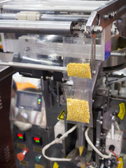 Fototapeta premium Automatic packing machine with plastic bag and paper box