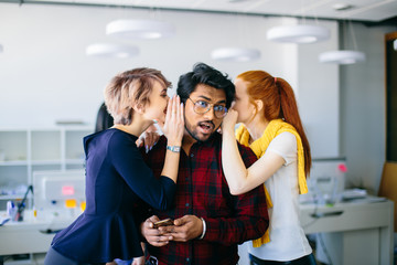 two female office workes wispering important news to Indian chief.. procuring employee.love...