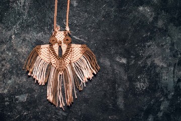 homemade owl pendant on a dark background top view with copy space