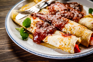 Pancakes with cream and strawberries