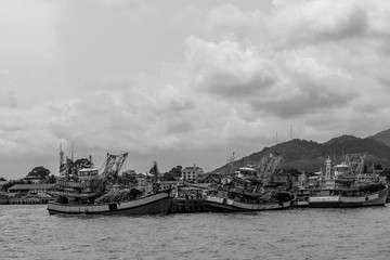 Fototapeta premium Fisherman boat on the sea with black and white.
