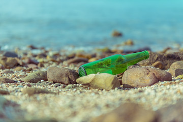 Surface of green bottle on the beach with vintage style.