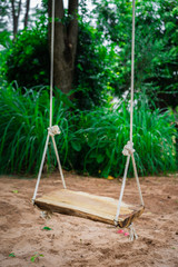 Fototapeta na wymiar wooden swing in garden