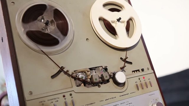 Play and rewind the tape in the old reel tape recorder, Old reel-to-reel tape deck, the tape is twisted in coils on record player