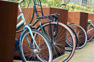 Fototapeta na wymiar Close up of parked bicycles on the street in Hague, Holland, Netherlands