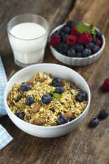 Homemade granola with fresh berries and mint, served with milk