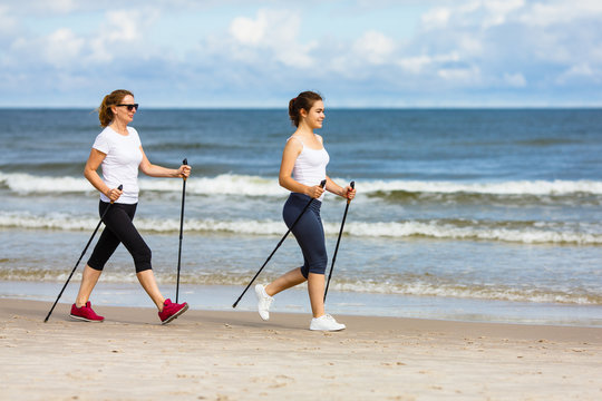 Nordic walking - two women training on beach