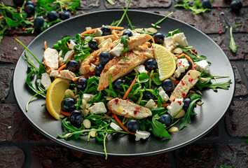 Fresh Chicken salad with Blueberries, feta, carrots, nuts and green vegetables. healthy food concept