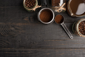 Preparation of coffee, ground coffee, coffee beans, on a dark background, top view with empty space for writing or advertising