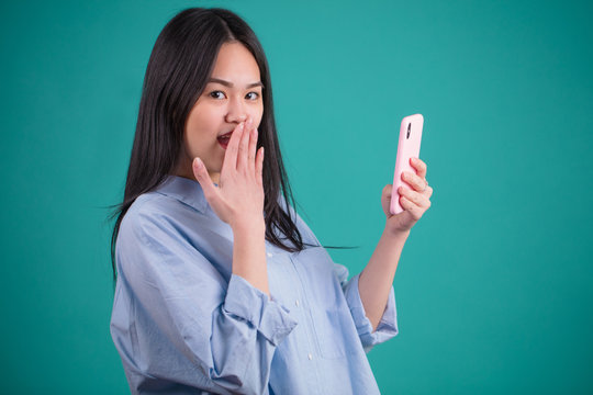 Portrait of surprised anxious Asian woman expressing shock, fear or amasement
