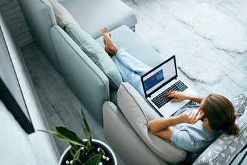 Young Man With Laptop At Home.