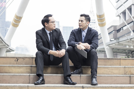 two business talking with partner about business and invetment  on way to office