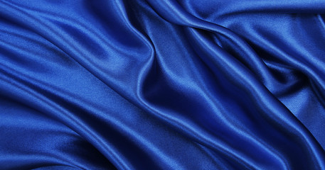 Obraz premium Smooth elegant blue silk or satin luxury cloth texture as abstract background. Luxurious background design