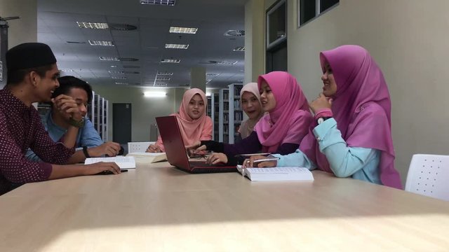 4K footage of Southeast Asian Muslim students having discussion and communicating to each other.