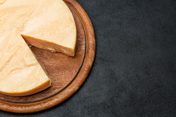 Whole round Head and pieces of parmesan or parmigiano