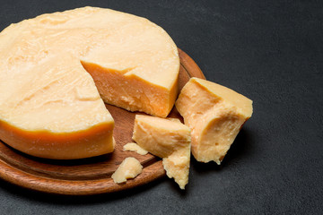 Whole round Head and pieces of parmesan or parmigiano