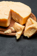 Whole round Head and pieces of parmesan or parmigiano