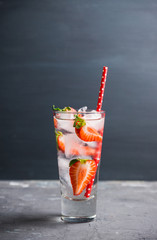 Cocktail with ripe strawberry on the rustic background. Selective focus.