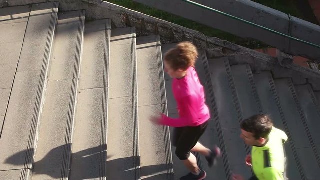 healthy young  couplerunning  on steps  at early morning