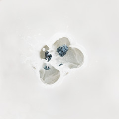 Obraz na płótnie Canvas Splashing milk with raw berries on white background