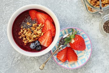 Smoothie bowl. Berrie smothie with chia seeds, granola and blueberry topping. Super food, clean eating,plant based concept. Copy space